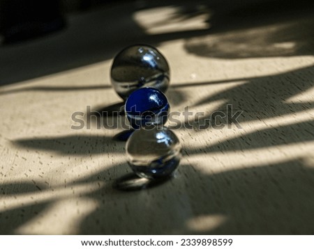 Multicolored glass balls rhythmically stacked on a wooden surface