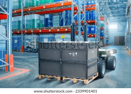 Unmanned forklift. Modern warehouse equipment. Forklift robot moves crate hazardous products. Automated warehouse. Forklift with remote control. Robot for warehouse delivery. Robotization production Royalty-Free Stock Photo #2339901401