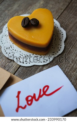 Heart shaped Mocca cake with cup of coffee, coffee beans and Valentine deocrations