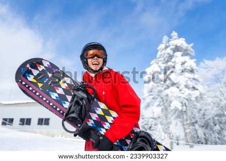 Portrait of Asian woman practice snowboarding on snow mountain at ski resort. Attractive girl enjoy and fun outdoor active lifestyle travel nature and winter extreme sport training on holiday vacation