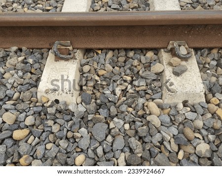 Iron Railway Train Track Rails With Rocky Ballast Bolts and Sleepers  Royalty-Free Stock Photo #2339924667