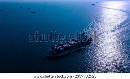 night process blue tone of cargo container ship sailing full speed in sea to import export goods and distributing products to dealer and consumers worldwide, by container ship Transport business