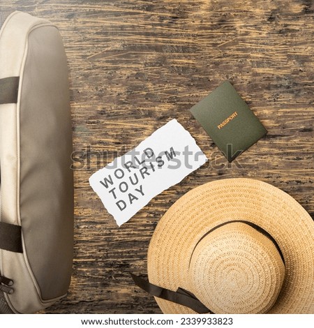 Hat and bag with passport on a wooden background. World tourism day concept