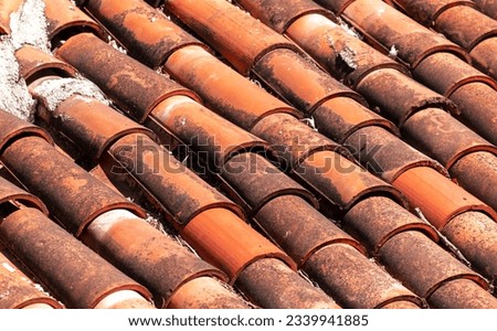 Old tiles on the roof of the house as an abstract background. Texture.