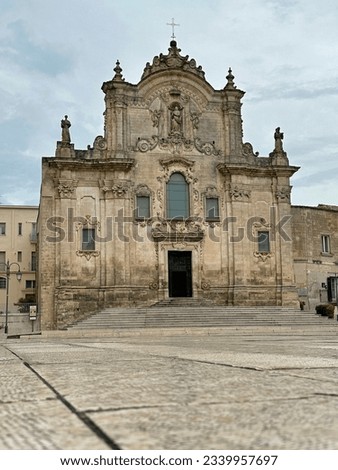 Chiesa di San Francesco d'Assisi (or Saint Francis of Assisi Catholic Church) of Matera, Italy is shown during the day in a vertical view.

