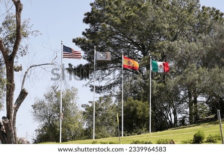 The American flag alongside the Kumeyaay, Mexican and Spanish flags on the Presidio Hill in San Diego, CA USA.