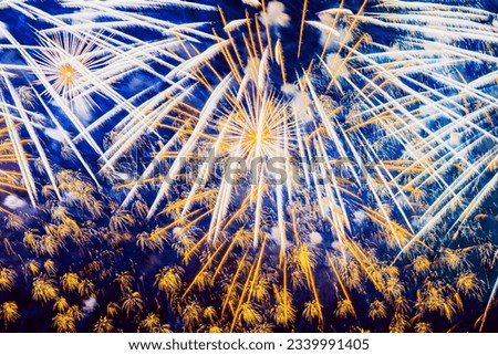 Bright Holiday Fireworks with sparks, comets, colored smoke and vivid nebula on blue sky similar to painting of impressionists. Festive colorful backdrop