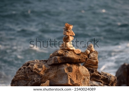 Rock, stone, textured. Background for design.folded pyramid of smooth stones on the seashore. rest and relaxation on vacation.selective focus.Lagori (Pitthu)- childhood Indian game.
