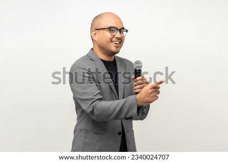 Businessman speaker with high quality dynamic microphone speaking talking with people on isolated white background. Male testing microphone voice for interview. Motivation life coach in training Royalty-Free Stock Photo #2340024707