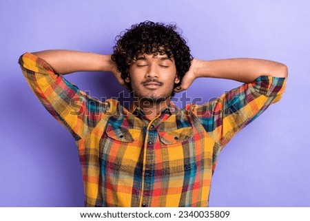 Portrait of young chilling guy after discotheque hangover relaxation wear plaid shirt stylish costume isolated on violet color background
