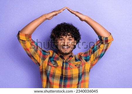 Photo of funny excited guy realtor showing hands together gesturing roof protect himself versus raining isolated on purple color background