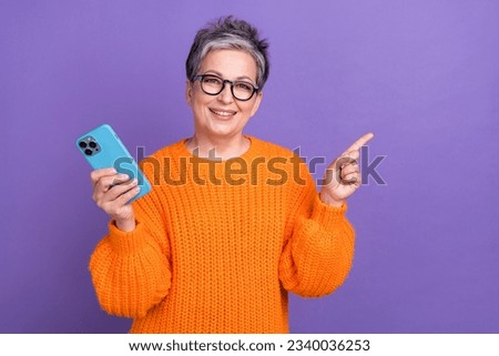 Photo of pretty sweet woman dressed orange sweater chatting twitter telegram facebook empty space isolated violet color background