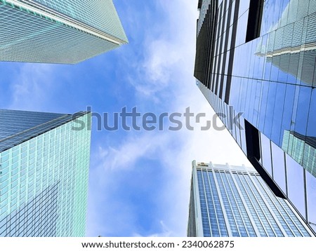 Looking up at business buildings, Concept for corporate, business center, finance and background Royalty-Free Stock Photo #2340062875