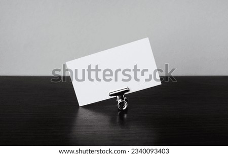 Blank white business card and paper clip. Template for graphic designers portfolios.