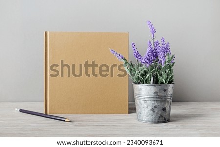 Blank kraft book, pencil and artificial lavender. Template for graphic designers portfolios.