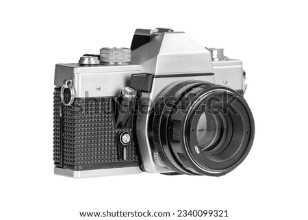 35mm Vintage silver SLR film camera with lens attached on white background. Royalty-Free Stock Photo #2340099321