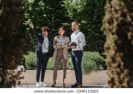Business leaders discussing new business strategies, ideas and opportunities during meeting out in the city Royalty-Free Stock Photo #2340115601
