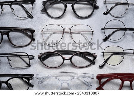 Many different glasses on light grey background, above view Royalty-Free Stock Photo #2340118807