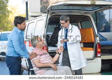 Doctor receiving old man from ambulance and checking while moaning in pain. Royalty-Free Stock Photo #2340124181