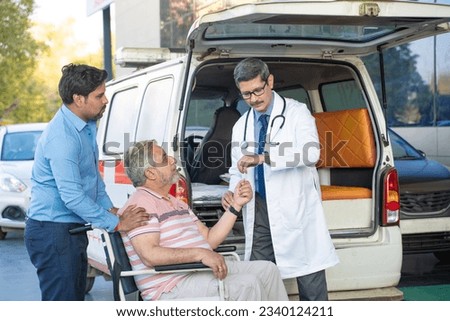 Doctor receiving old man from ambulance and checking while moaning in pain. Royalty-Free Stock Photo #2340124211