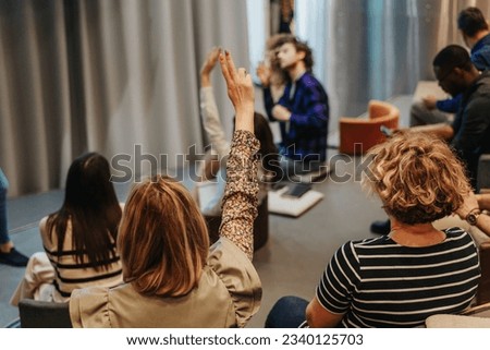 Shot of business people raising hands to ask question during conference seminar