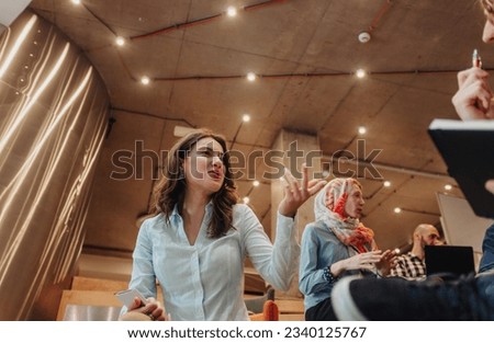 Beautiful girl gesticulating with hand while having a conversation with her boyfriend, coworker, at work Royalty-Free Stock Photo #2340125767