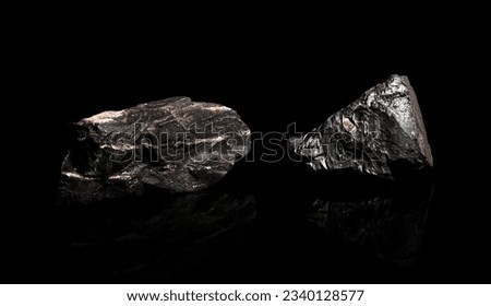 Macro Close up image of raw material Manganese Ore rock isolated on black reflective background Royalty-Free Stock Photo #2340128577