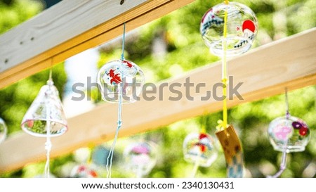 wind chime swaying in the wind Royalty-Free Stock Photo #2340130431