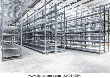 Empty metal shelving in a warehouse Royalty-Free Stock Photo #2340142591