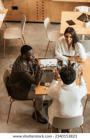 High view of businesspeople working and explaining something to each other at the office Royalty-Free Stock Photo #2340153823