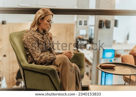 Uptight businesswoman waiting for her client at the office. Clients late. Blonde, middle-aged businesswoman waiting for her client at the coffee shop Royalty-Free Stock Photo #2340153833
