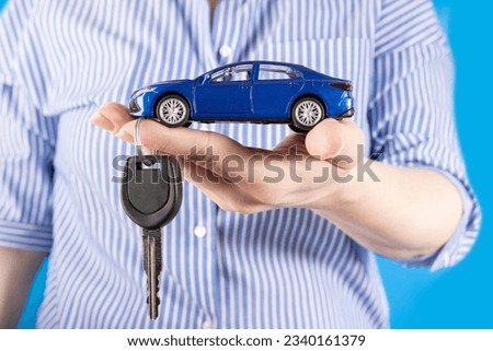 agent manager holding a car and car key in hand, car loan, credit for vehicle