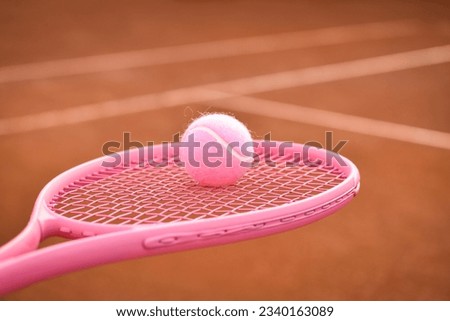 Pink tennis racket and ball with space for your text   
