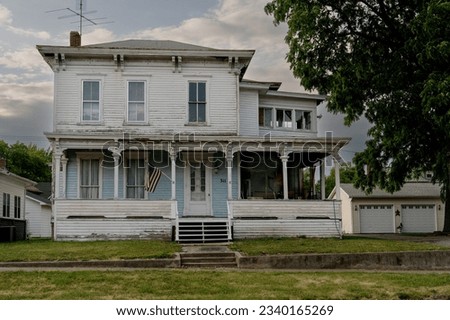 Old abandoned house with American flag   Royalty-Free Stock Photo #2340165269