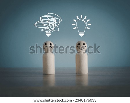 New idea bulb to solve problems, new idea, creativity and messy idea bulb. On a wooden mannequin with happy and unhappy faces. Royalty-Free Stock Photo #2340176033