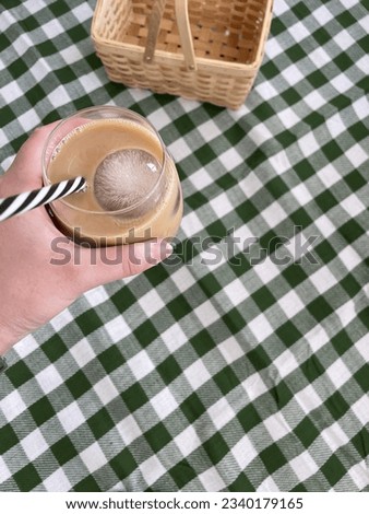 Iced coffee on a picnic cloth