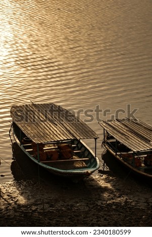 Wooden boat by the lake with anime background.
