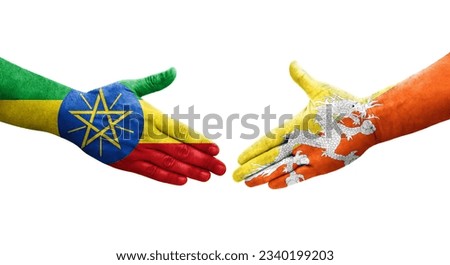 Handshake between Bhutan and Ethiopia flags painted on hands, isolated transparent image.