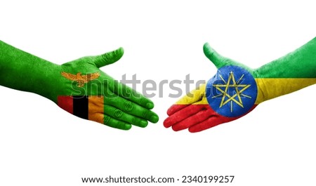 Handshake between Ethiopia and Zambia flags painted on hands, isolated transparent image.