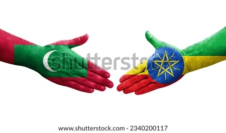 Handshake between Ethiopia and Maldives flags painted on hands, isolated transparent image.