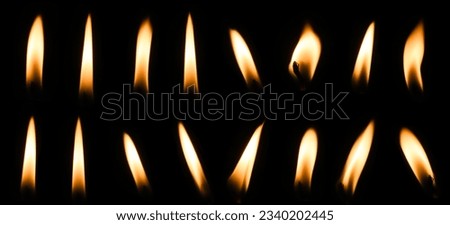 Set of candle flames on black background Melted wax candles that burn at night white candle burning in dark candlelight Royalty-Free Stock Photo #2340202445