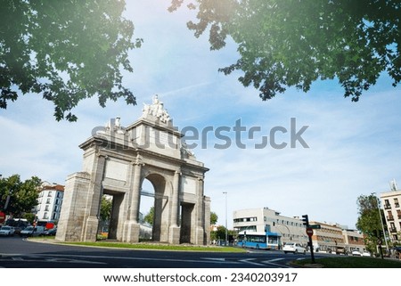 Majestic Toledo Gate in Madrid with Roundabout around foliage and city panorama