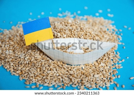 Ukrainian flag grain wheat and spikelets on dark background. Ukraine Russia conflict, Grain deal and problem of blockade of ports, grain corridor Royalty-Free Stock Photo #2340211363
