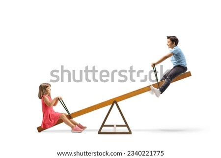 Children playing on a wooden seesaw isolated on white background Royalty-Free Stock Photo #2340221775