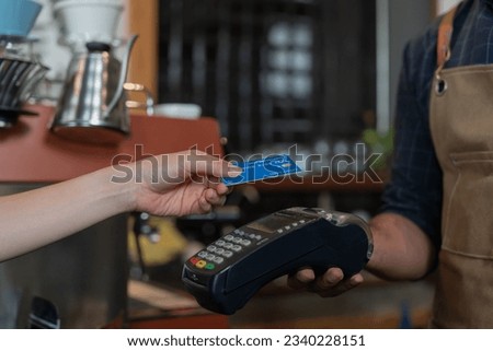 Woman use credit card pay money online in cafe restaurant with a digital payment without cash. accumulate discount. E wallet, technology, pay online, credit card, bank app. daily life payment
