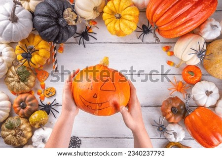 Preparation for Halloween with carving cutting pumpkin Jack Lantern. Female, woman and kids hands in frame, decorate, drawing and carves scary Halloween party Pumpkin top view copy space Royalty-Free Stock Photo #2340237793