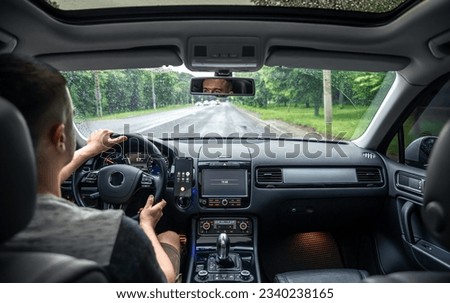 Hands on the wheel when driving from inside the car. Royalty-Free Stock Photo #2340238165