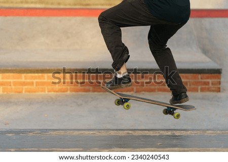 Leisure activity in spring day. Sportive lifestyle. Young man riding skateboard. Photography of feet and skateboard. Closeup photography. Panoramic image. Low angle view