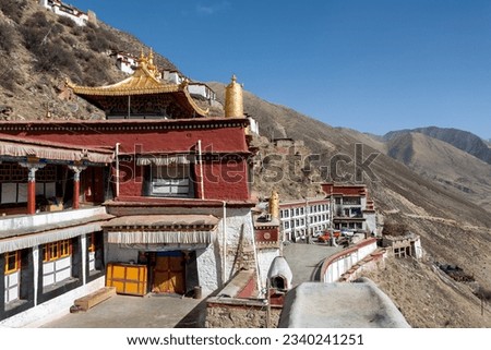 DRIGUNG TIL MONASTERY, TIBET: colorful buildings and dry sunny winter landscape. Drigung Monastery is a notable monastery in the Lhasa Prefecture, Tibet, known for performing sky burials