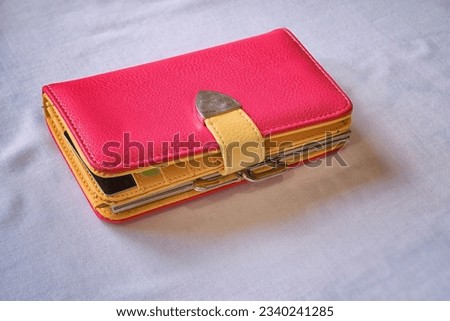 Leather wallet for a phone with a compartment for cards on a white background close-up.